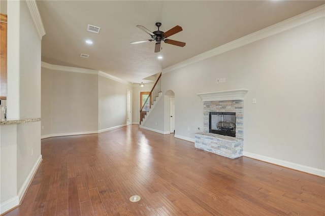 15613 Wood Brook Ln, College Station, TX 77845 - unfurnished living room featuring a fireplace, wood finished floors, ceiling fan, stairway, and crown molding