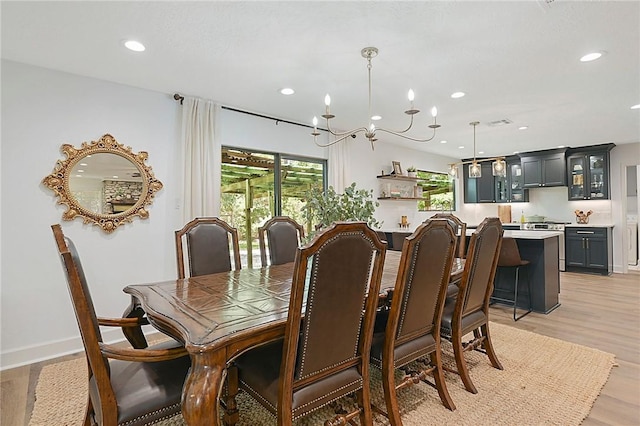 dining area featuring plenty of natural light, recessed lighting, and a chandelier