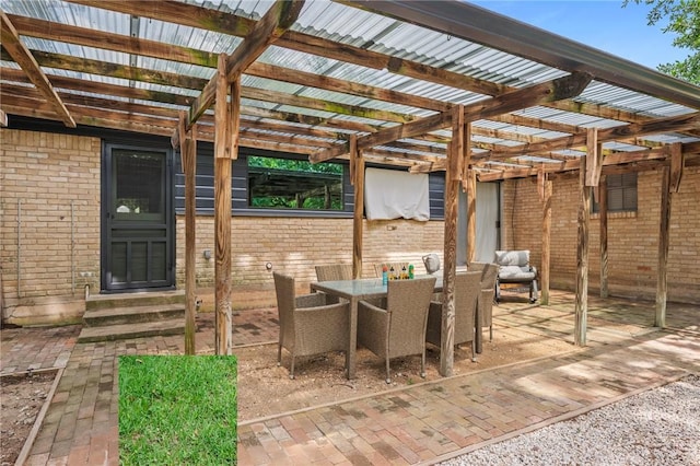 view of patio featuring a pergola, outdoor dining area, and entry steps
