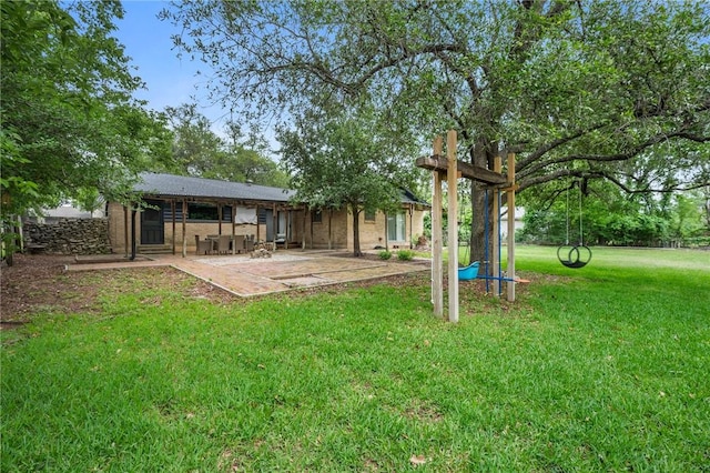 back of property with a patio and a yard