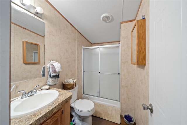 bathroom featuring a shower with shower door, toilet, crown molding, wallpapered walls, and vanity