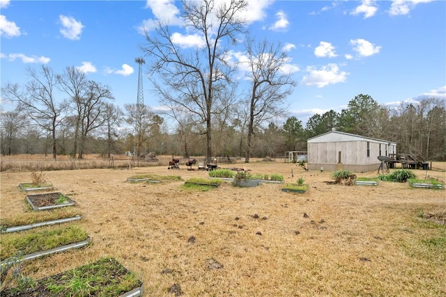 view of yard featuring a rural view and a vegetable garden