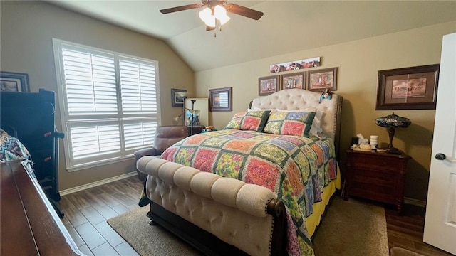 bedroom featuring ceiling fan, dark hardwood / wood-style flooring, and vaulted ceiling