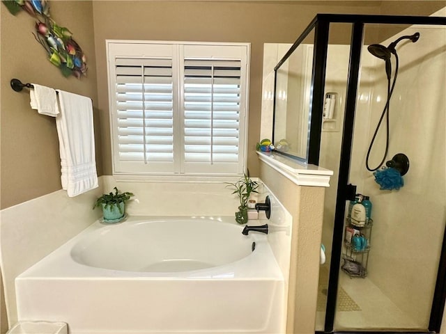 bathroom featuring separate shower and tub