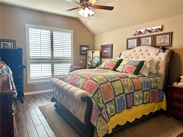 bedroom with ceiling fan, dark hardwood / wood-style floors, and lofted ceiling