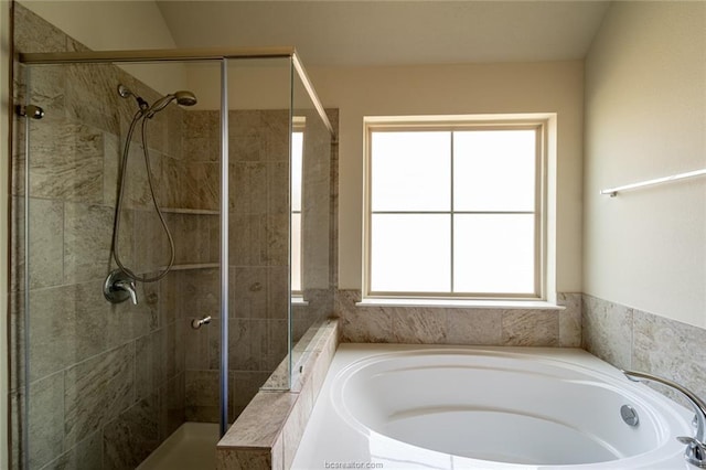 full bath with a stall shower and a garden tub