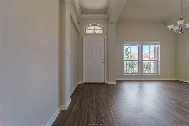 foyer with a chandelier, dark wood-style flooring, baseboards, and crown molding