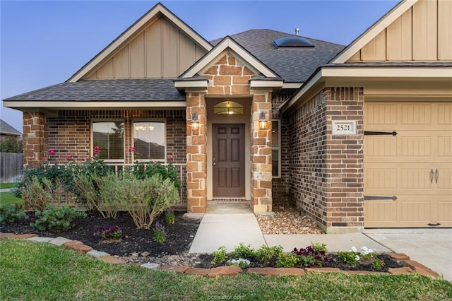 view of front of home with board and batten siding, brick siding, a shingled roof, and a garage