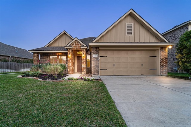 craftsman-style home with board and batten siding, brick siding, driveway, and a garage