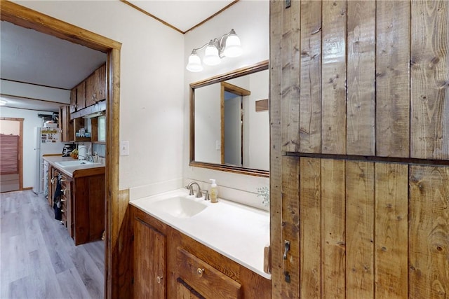 bathroom with hardwood / wood-style floors and vanity