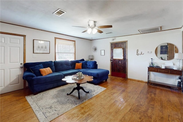 living room featuring hardwood / wood-style floors and ceiling fan