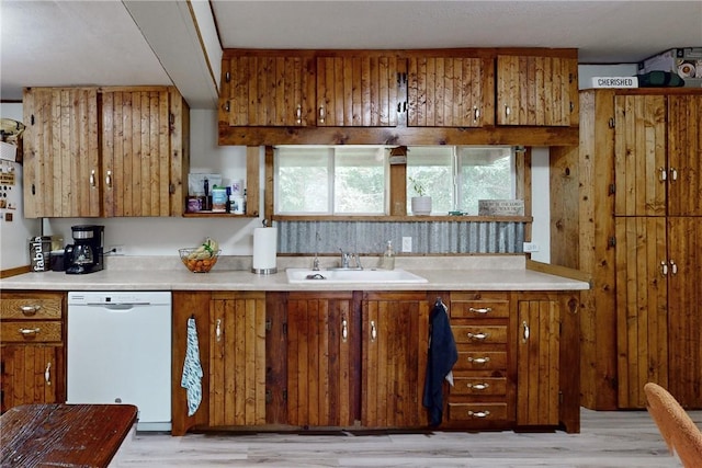 kitchen featuring dishwasher, light hardwood / wood-style floors, and sink