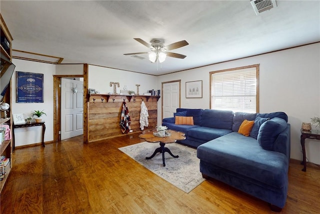 living room with dark hardwood / wood-style flooring and ceiling fan