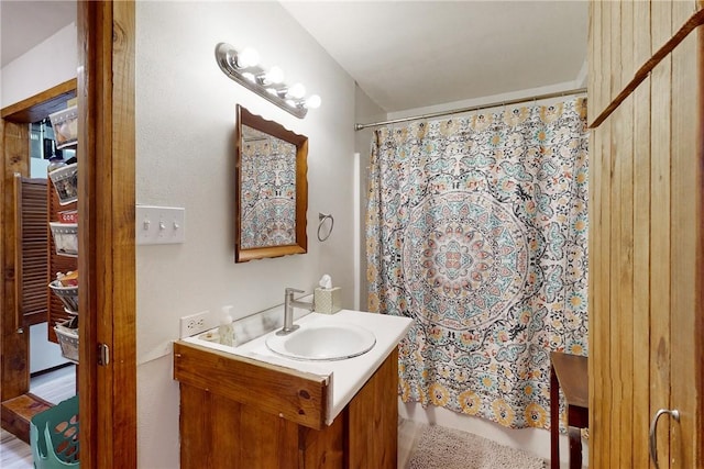 bathroom featuring hardwood / wood-style floors, vanity, and curtained shower