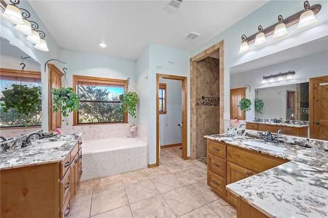 bathroom with plus walk in shower, tile patterned floors, and vanity