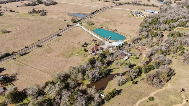 birds eye view of property with a rural view and a water view