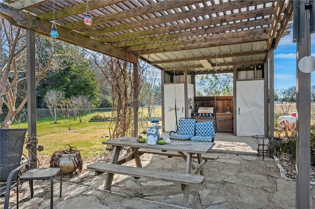 view of patio / terrace featuring a pergola, exterior kitchen, outdoor dining area, and a fenced backyard