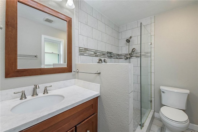 806 Matous Dr, Bryan, TX 77802 - full bathroom featuring a tile shower, toilet, vanity, and tile patterned floors