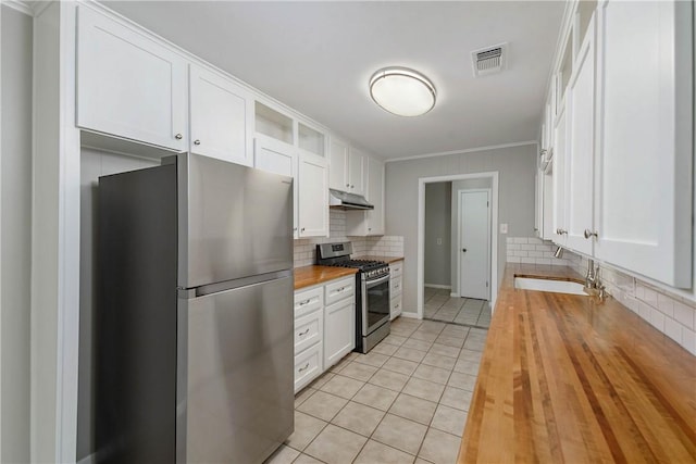 806 Matous Dr, Bryan, TX 77802 - kitchen featuring butcher block counters, stainless steel appliances, under cabinet range hood, open shelves, and white cabinetry