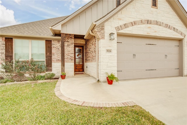 property entrance featuring a lawn and a garage