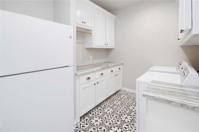 washroom featuring cabinets and washer and dryer