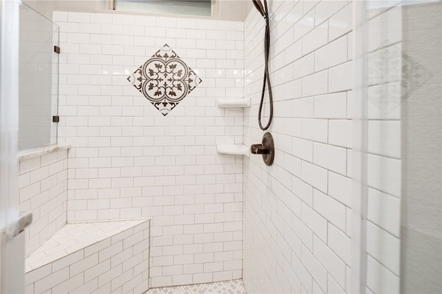 bathroom with tiled shower