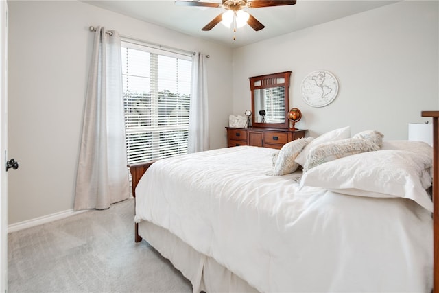 bedroom with ceiling fan and light colored carpet