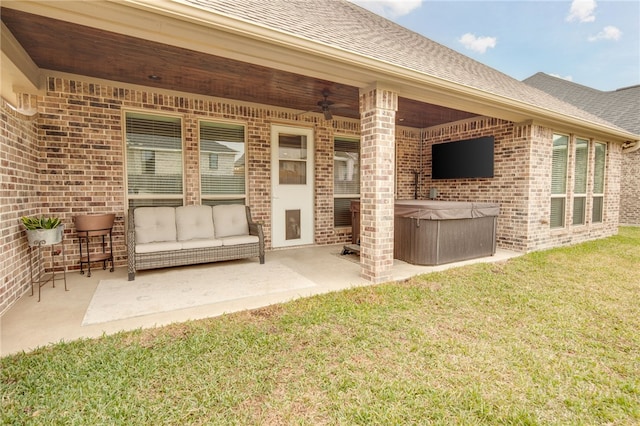 view of patio / terrace with a hot tub and ceiling fan