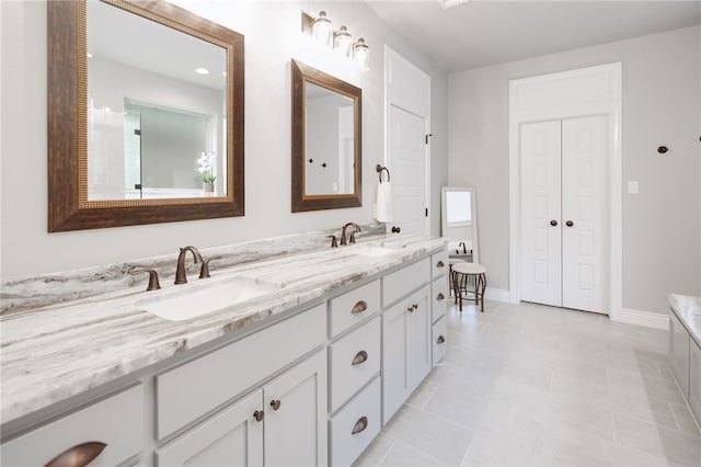 bathroom with tile patterned flooring and vanity