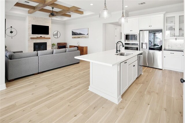 3609 Llano River Dr, College Station, TX 77845 - kitchen with appliances with stainless steel finishes, a sink, open floor plan, coffered ceiling, and beam ceiling