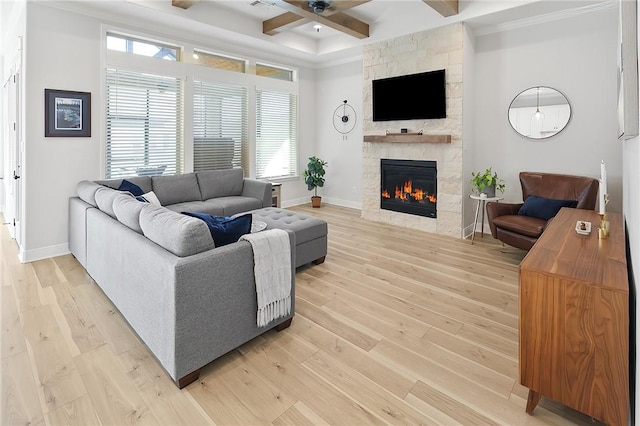 3609 Llano River Dr, College Station, TX 77845 - living area featuring a stone fireplace, a ceiling fan, light wood finished floors, ornamental molding, and beam ceiling