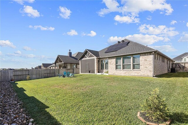 3609 Llano River Dr, College Station, TX 77845 - back of property featuring solar panels, brick siding, central AC, and a shingled roof