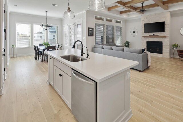 3609 Llano River Dr, College Station, TX 77845 - kitchen featuring dishwasher, a sink, open floor plan, light wood-type flooring, and beam ceiling