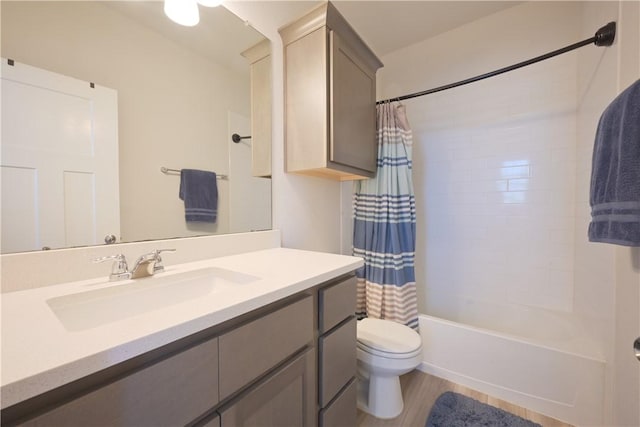 full bathroom with hardwood / wood-style floors, vanity, shower / bath combination with curtain, and toilet