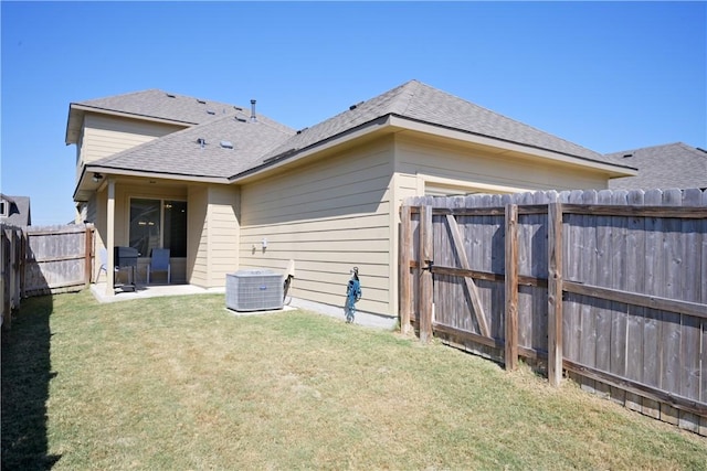 rear view of property with a lawn and a patio area