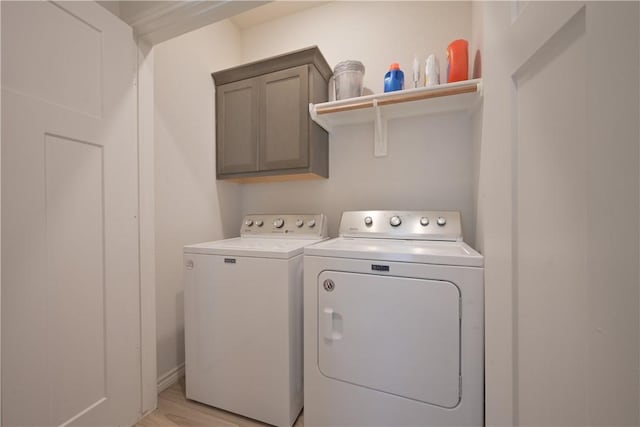 washroom with light hardwood / wood-style floors, cabinets, and independent washer and dryer