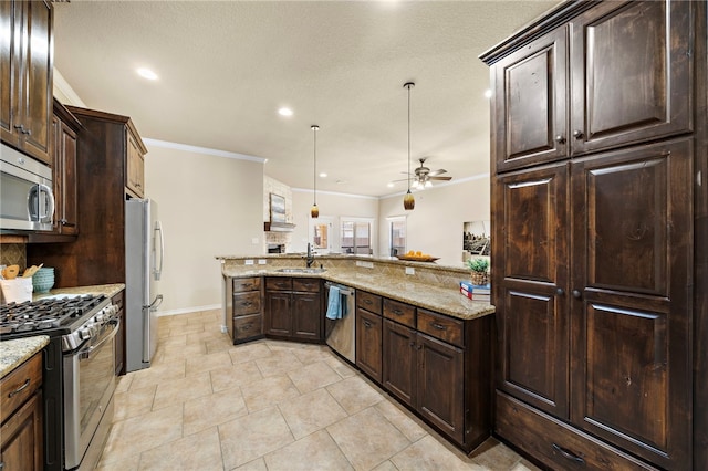 kitchen with light stone counters, hanging light fixtures, stainless steel appliances, ceiling fan, and sink