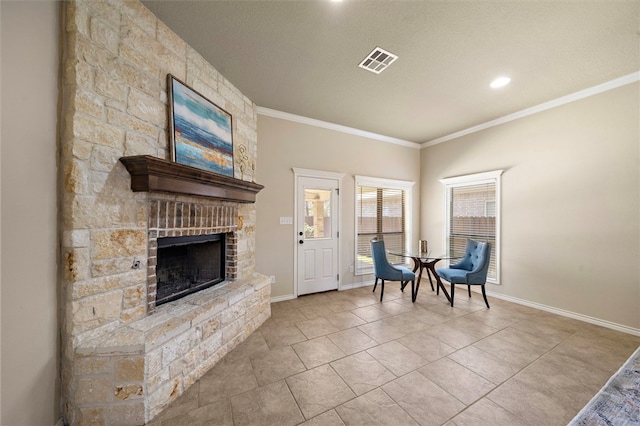 unfurnished room with a textured ceiling, light tile patterned floors, crown molding, and a stone fireplace