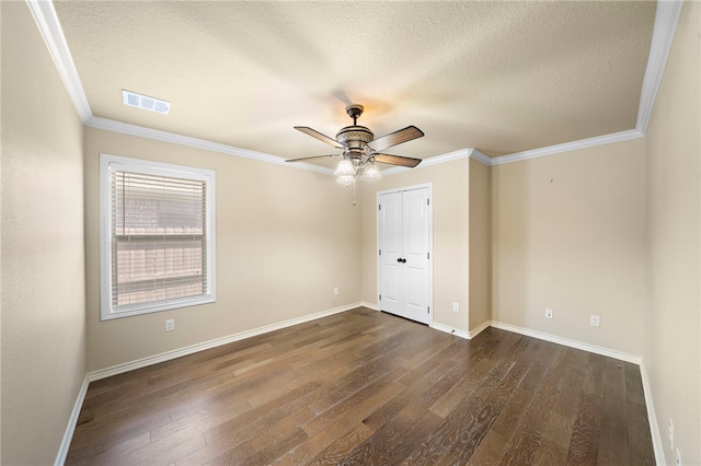 unfurnished bedroom featuring a closet, ceiling fan, crown molding, and dark wood-type flooring