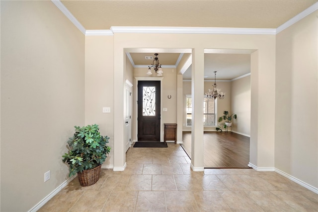 entryway featuring an inviting chandelier and crown molding