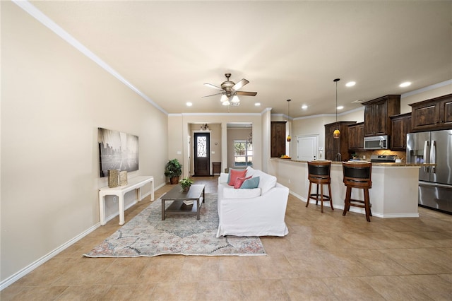 living room featuring ceiling fan and ornamental molding