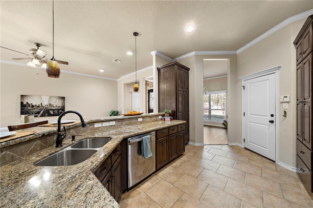 kitchen with sink, pendant lighting, stainless steel dishwasher, and light stone countertops