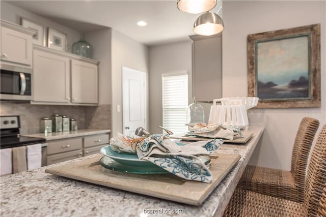 547 Hayes Ln, College Station, TX 77845 - kitchen with appliances with stainless steel finishes, backsplash, light countertops, and recessed lighting