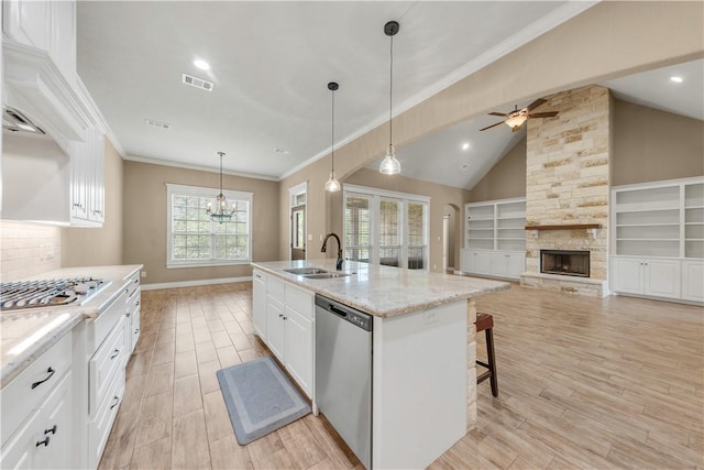 3520 Foxcroft Path, Bryan, TX 77808 - kitchen featuring stainless steel appliances, a sink, a ceiling fan, white cabinetry, and light wood-style flooring