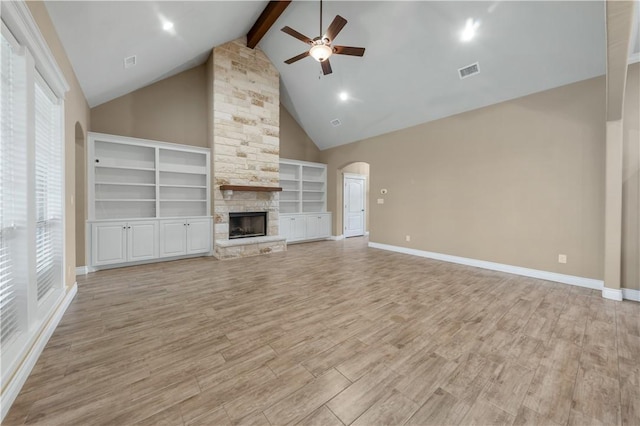 3520 Foxcroft Path, Bryan, TX 77808 - unfurnished living room featuring ceiling fan, arched walkways, beamed ceiling, high vaulted ceiling, and light wood-type flooring