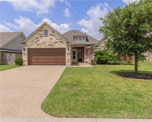 3520 Foxcroft Path, Bryan, TX 77808 - view of front facade with stone siding, an attached garage, driveway, and a front lawn