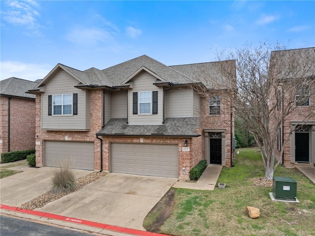 view of front of property with a shingled roof, concrete driveway, brick siding, and a garage