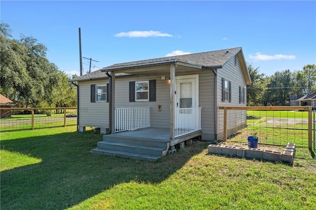 rear view of property featuring a yard