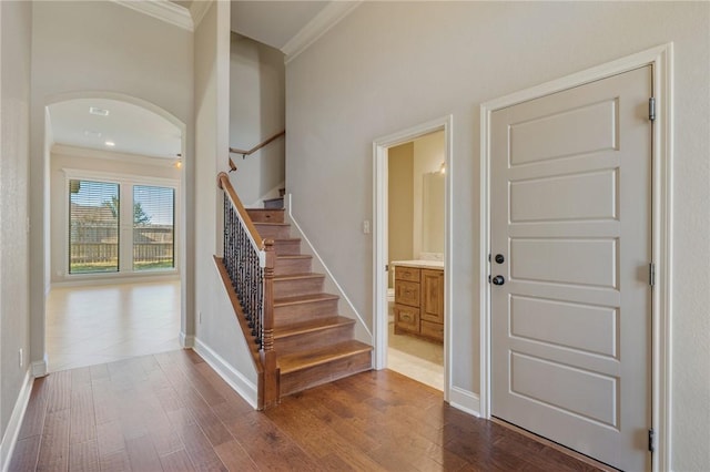 entryway featuring crown molding and hardwood / wood-style flooring