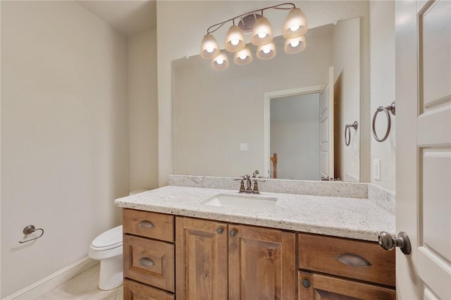 bathroom featuring tile patterned flooring, vanity, and toilet